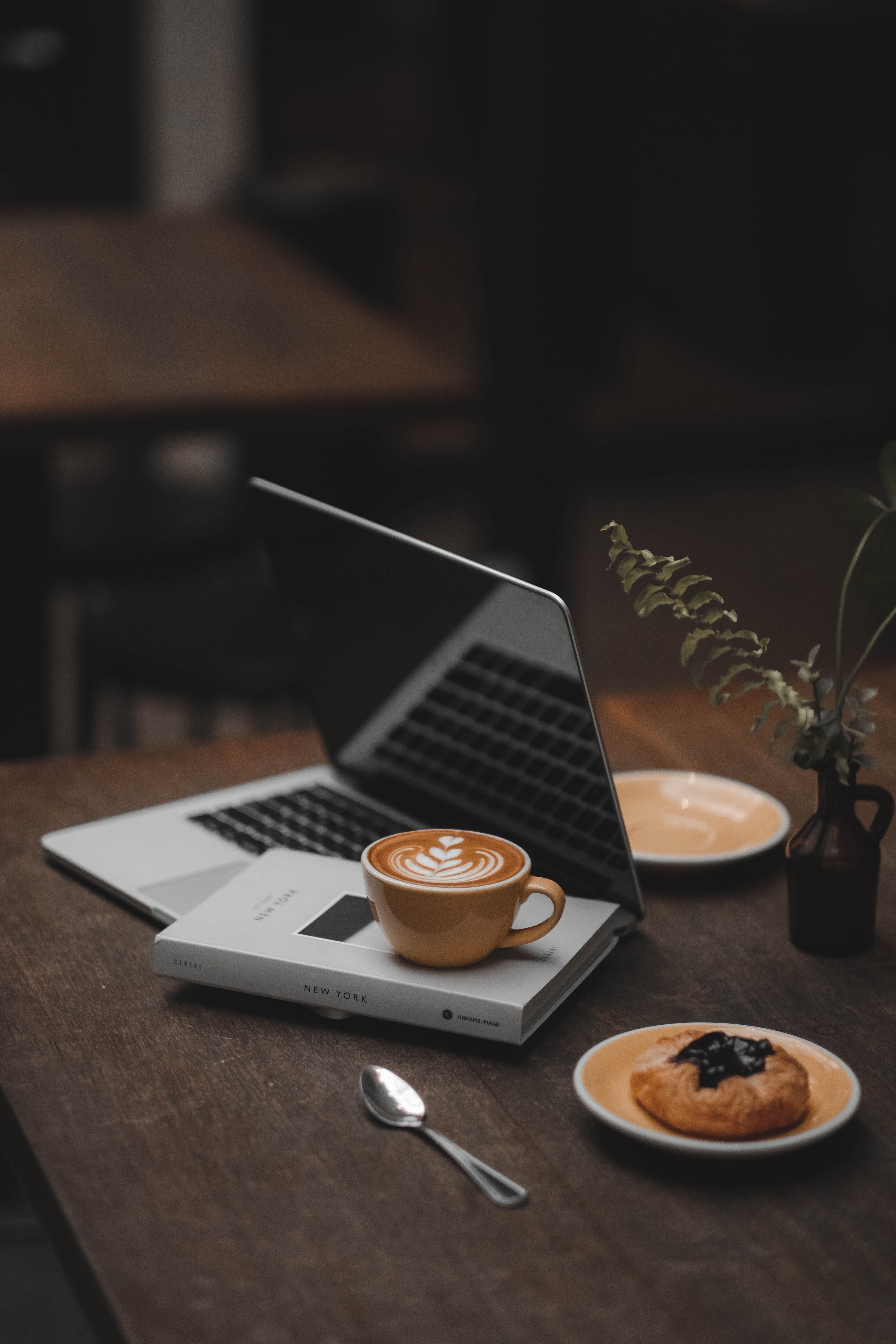 A quiet workspace with a laptop, coffee and notebook — the kind of desk development habour's research gets written from.